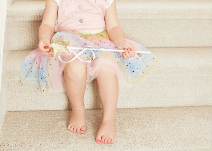 Baby sitting on stairs | Direct Flooring Center